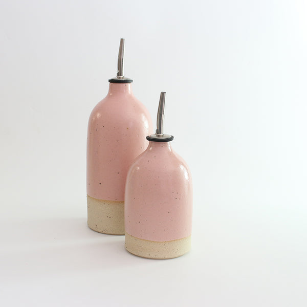 Small and large pink stoneware oil pourers