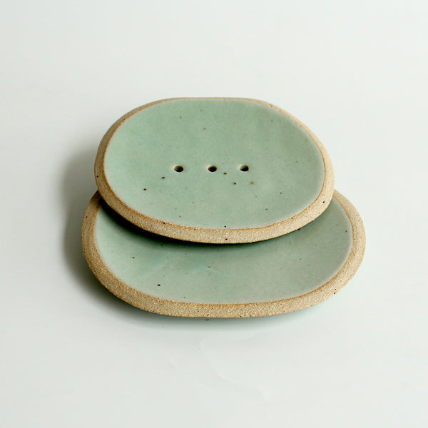 Small green soap dish stacked on top of large for size comparison