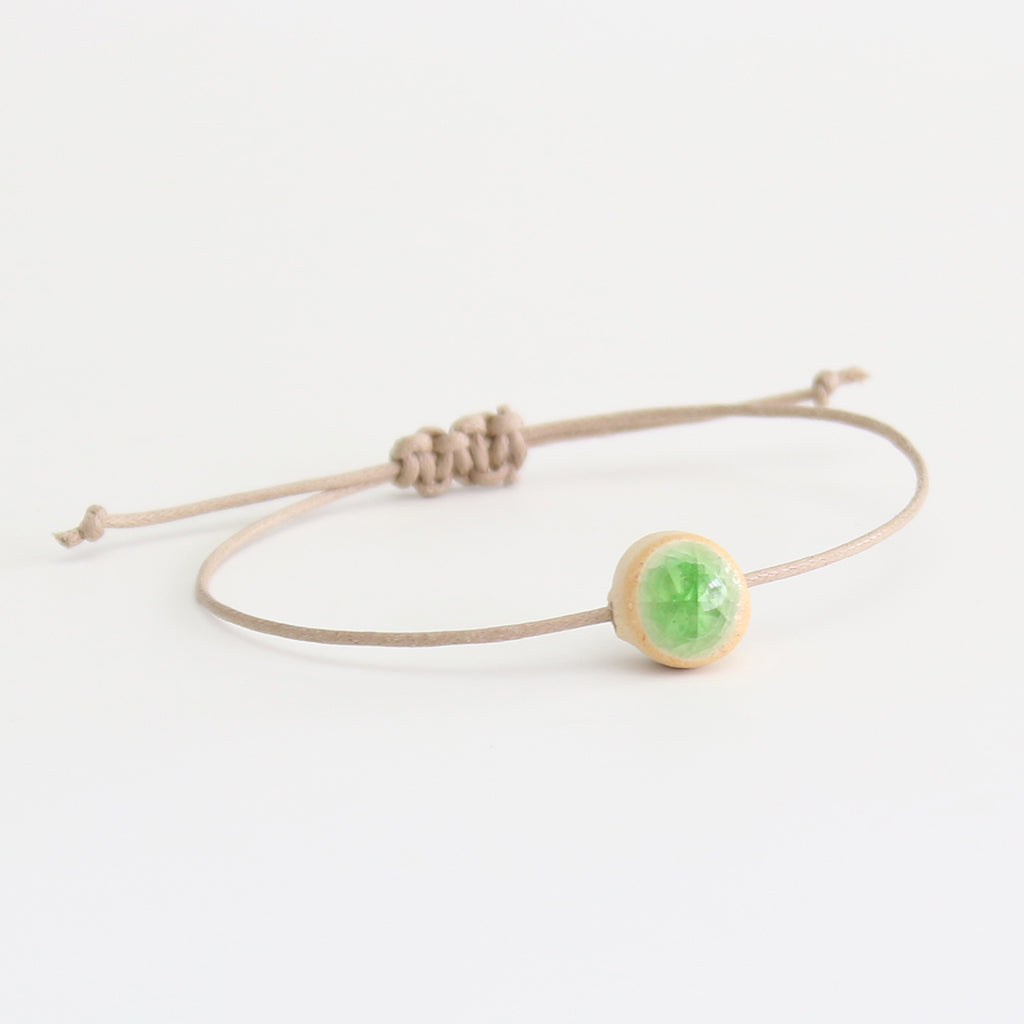 Recycled emerald green crackled glass ceramic circular bead light brown cord bracelet 
