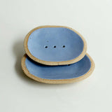 Small blue soap dish stacked on top of large for size comparison
