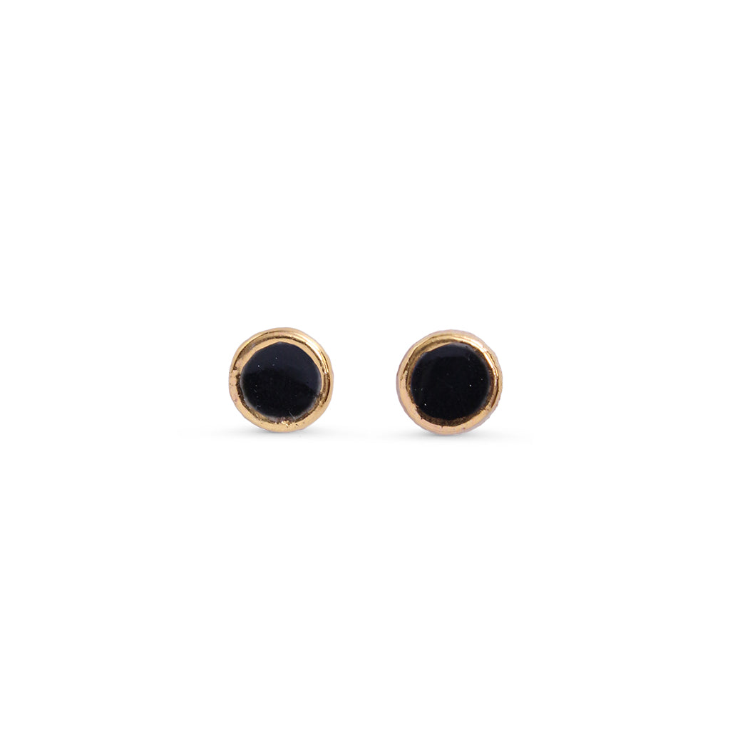 Pair of black round stud earrings on a white background