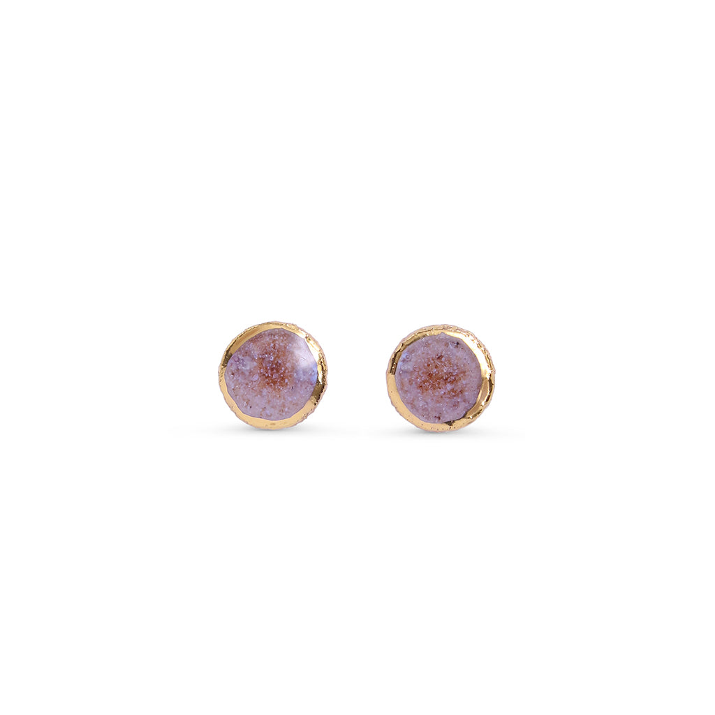 Round earrings with pink centres on a white background