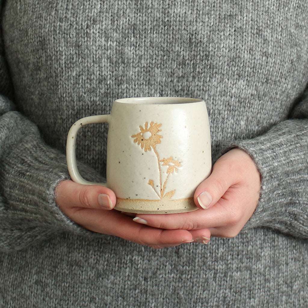 Hands holding Aster mug