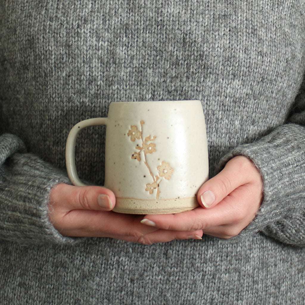 Hands holding Cherry Blossom mug
