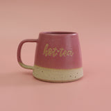 Pink ceramic mug with 'hot tea' text on a pink background handmade in the UK by Habulous Ceramics 