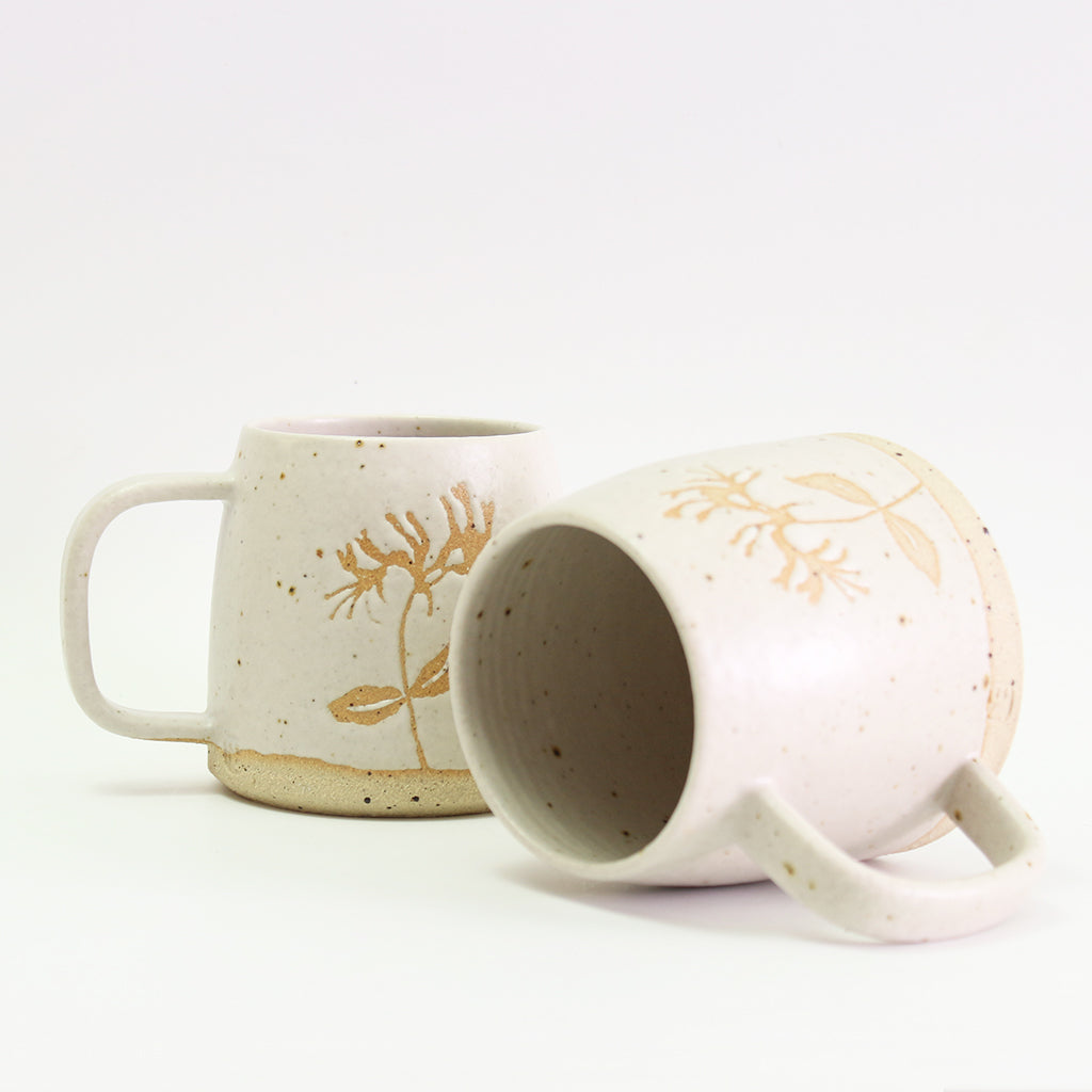 Two honeysuckle mugs, one on its side