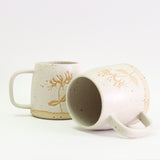 Two honeysuckle mugs, one on its side