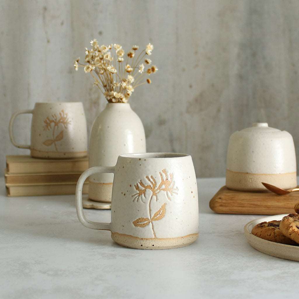 Honeysuckle mug in front of white ceramics table setting