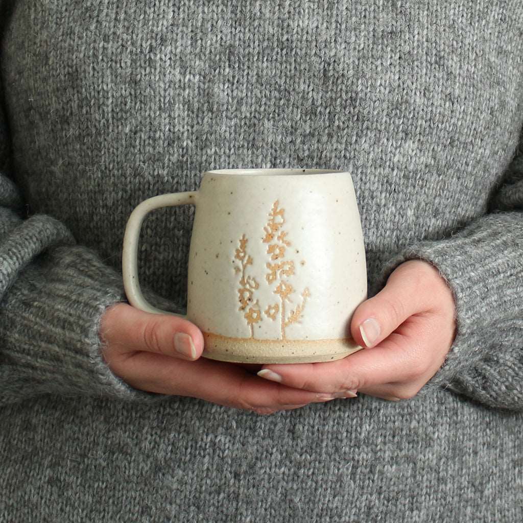 Hands holding Larkspur mug