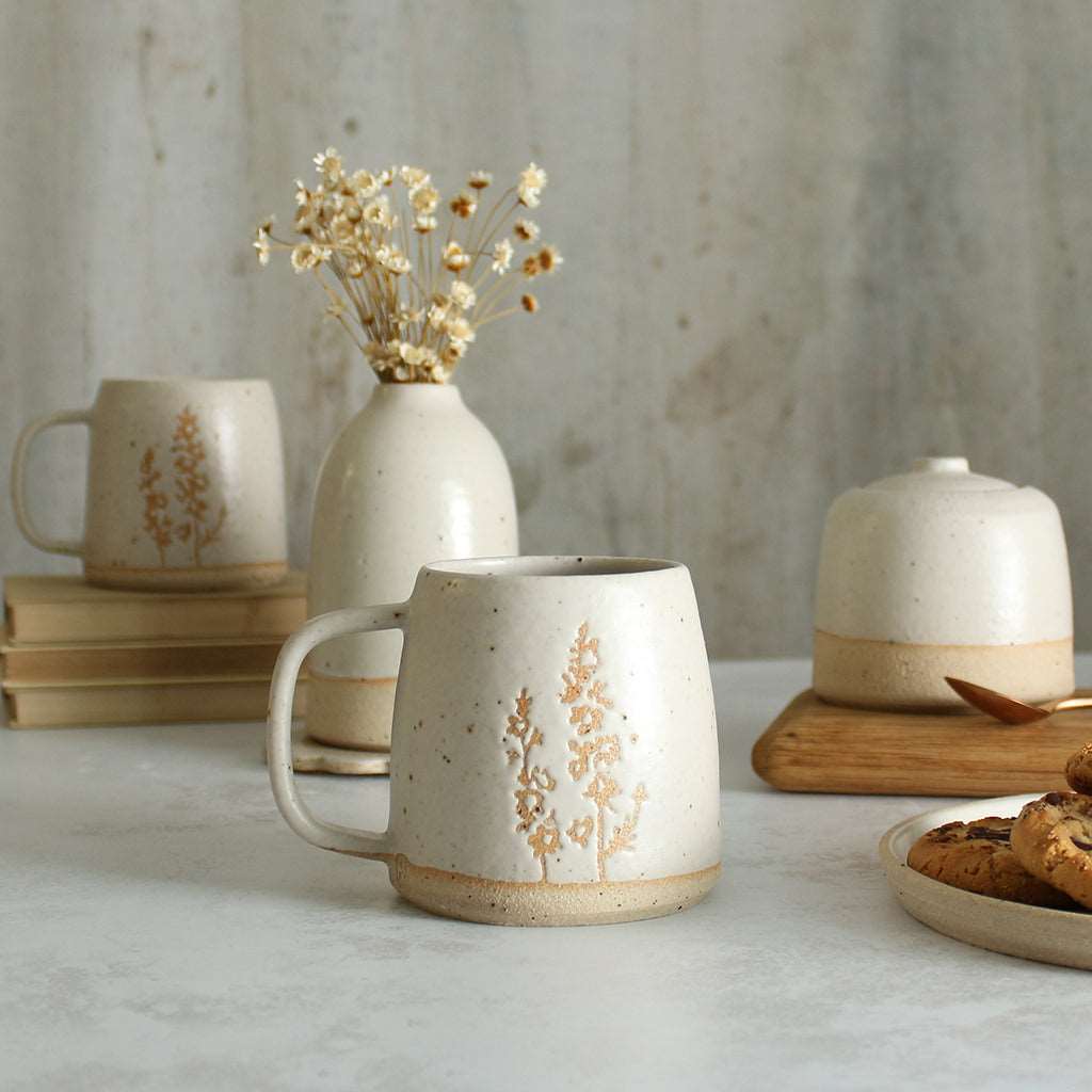 Larkspur mug in front of white ceramics table setting