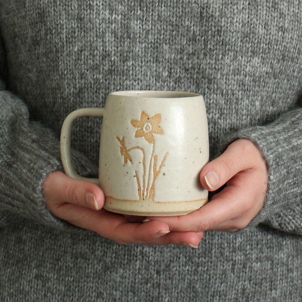 Hands holding Narcissus mug