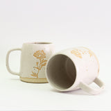 Two Peony mugs, one on its side