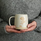 Hands holding Peony mug