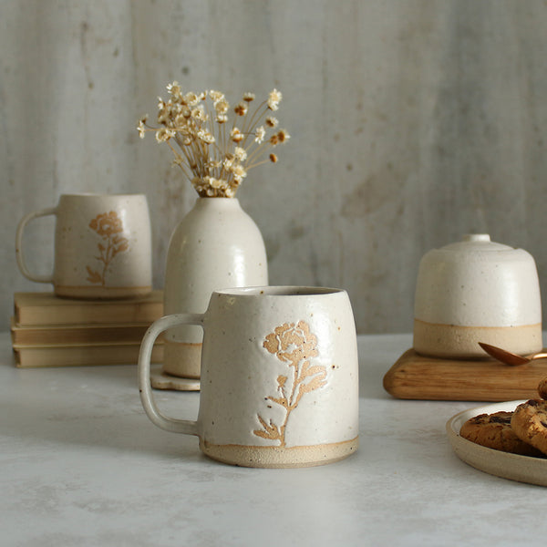 Peony mug in front of white ceramics table setting