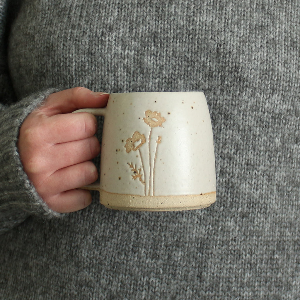 Hand holding Poppy mug