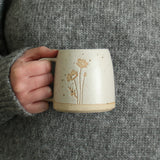 Hand holding Poppy mug