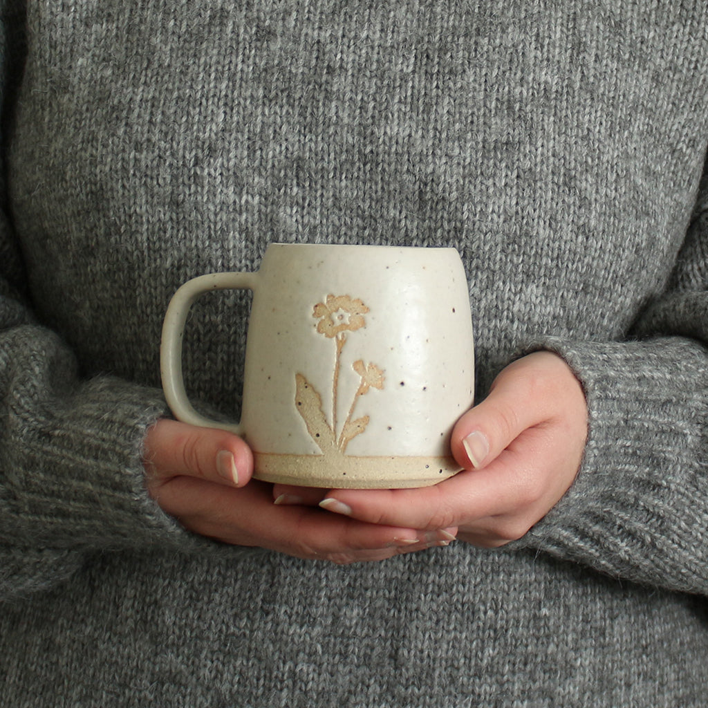 Hands holding a Primrose mug