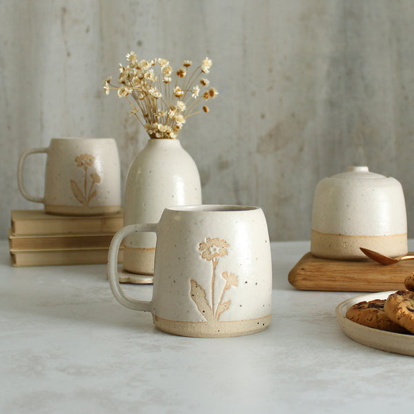 Primrose mug in front of white ceramics table setting