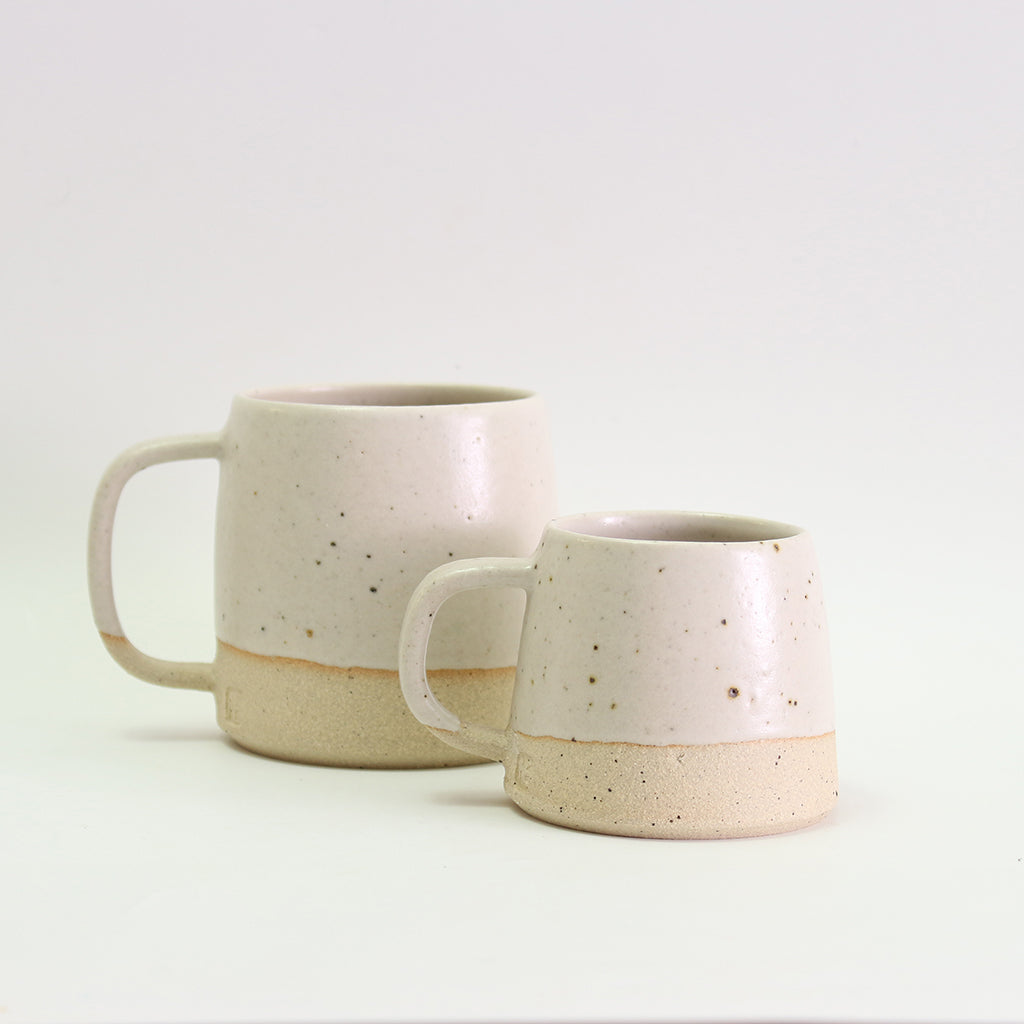off-white small mug and large mug