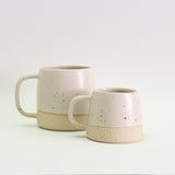 off-white small mug and large mug