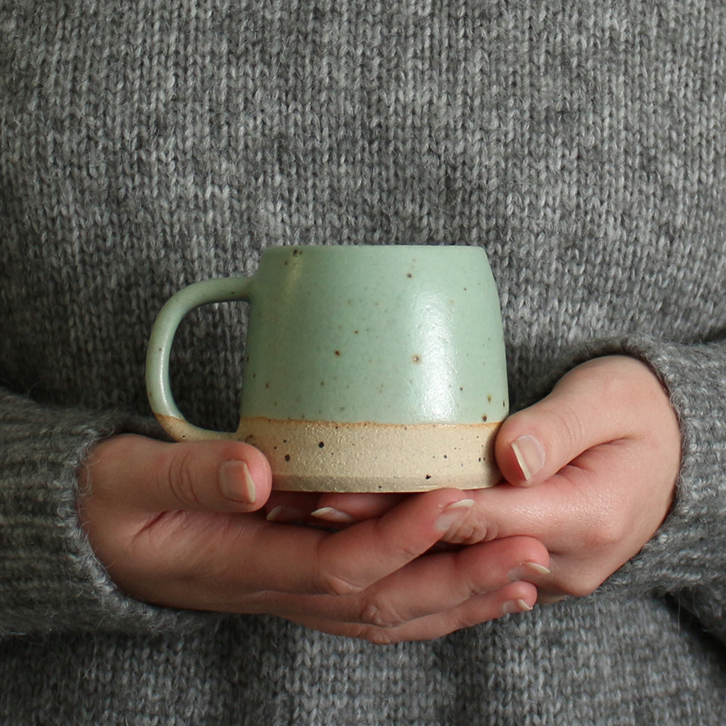 Hands holding mint green Small Stoneware Mug