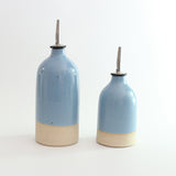 Size comparison of small and large oil pourer in blue