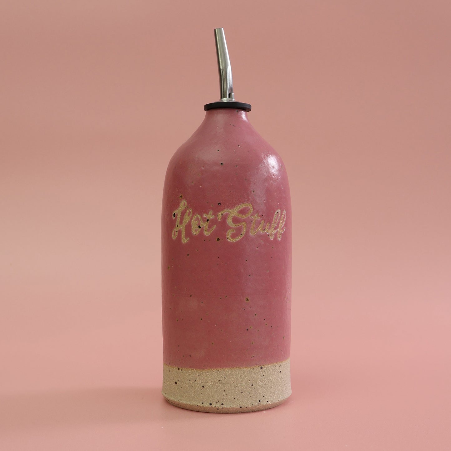 Handmade bright Pink Ceramic Oil Dispenser featuring 'Hot Stuff' text on a pink background