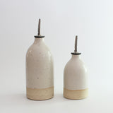 Size comparison of small and large white oil pourers