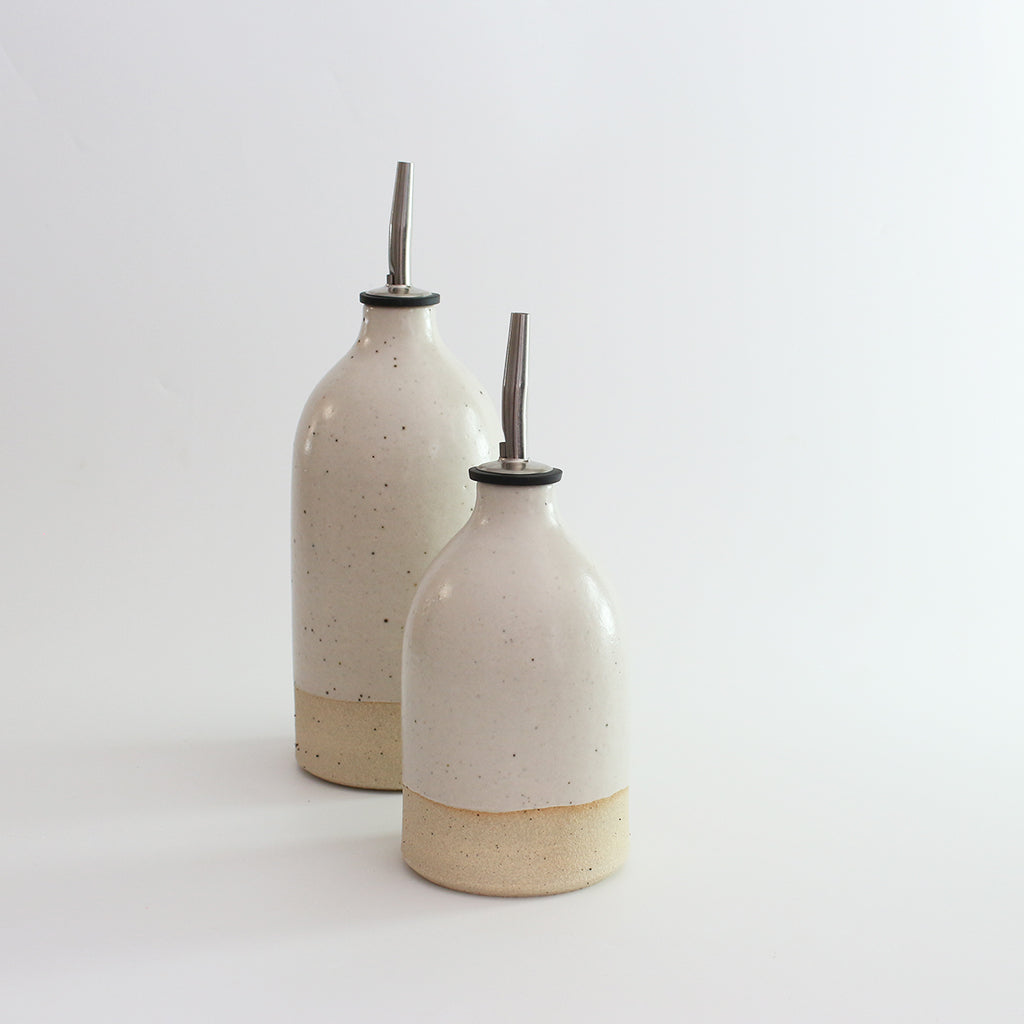 Small and large white stoneware oil pourers