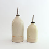Size comparison of small and large yellow oil pourer