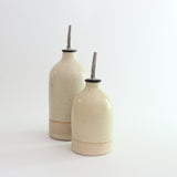 Yellow small and large oil pourer