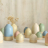 Different size and style vases in pastel colours