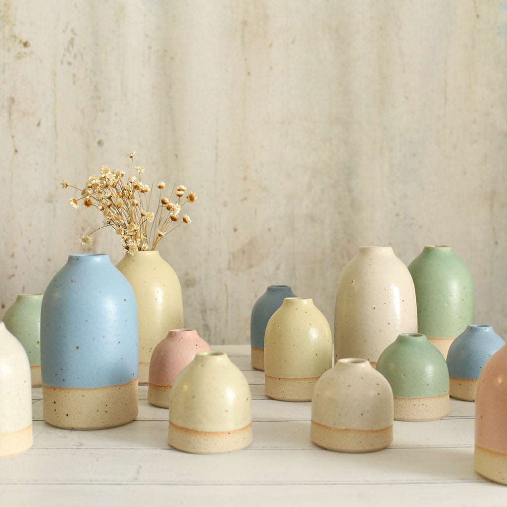 Different size and style vases in pastel colours