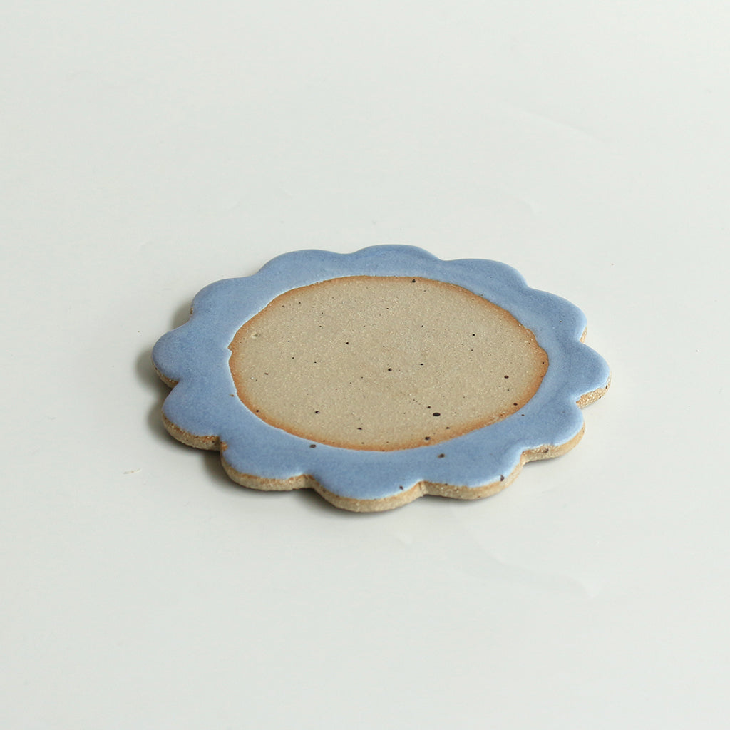 Close up of flecked stoneware and blue glazed petals