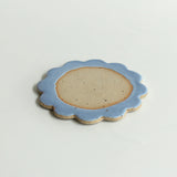 Close up of flecked stoneware and blue glazed petals