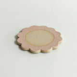 Close up of flecked stoneware and pink glazed petals