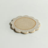 Close up of flecked stoneware and white glazed petals