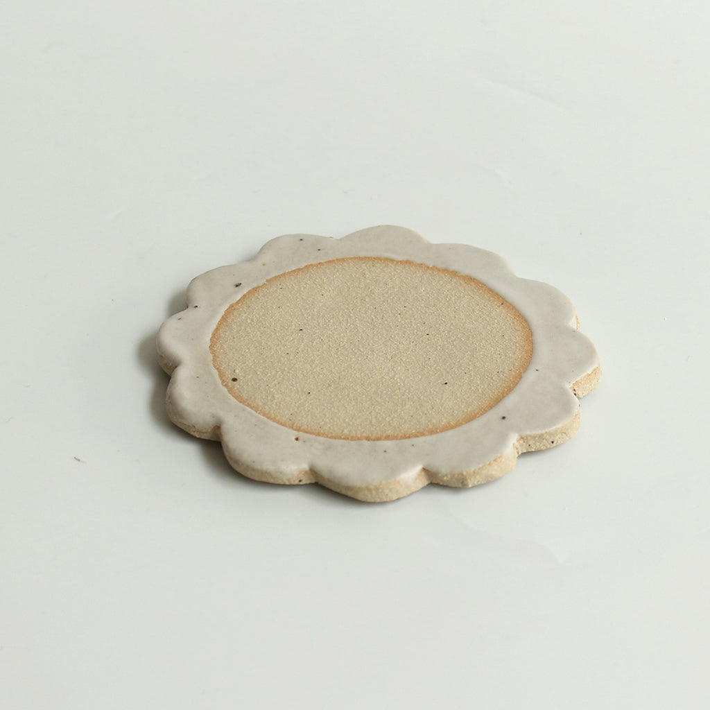 Close up of flecked stoneware and white glazed petals