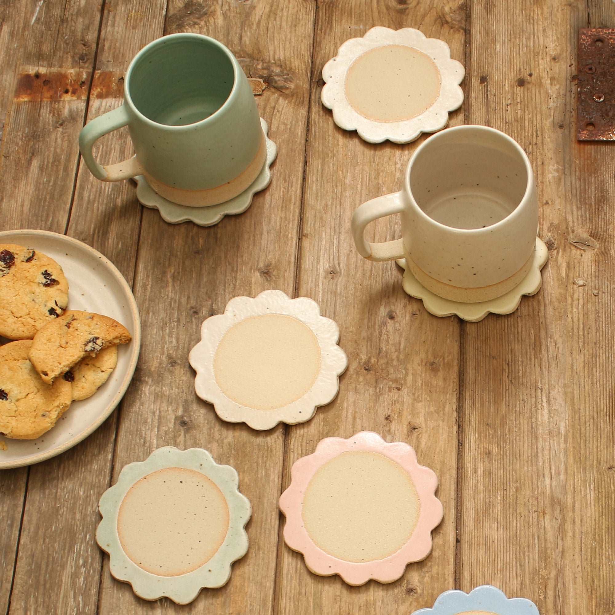 Flower coasters and mugs on table setting