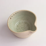 Above view of green herb shredder bowl showing pattern inside