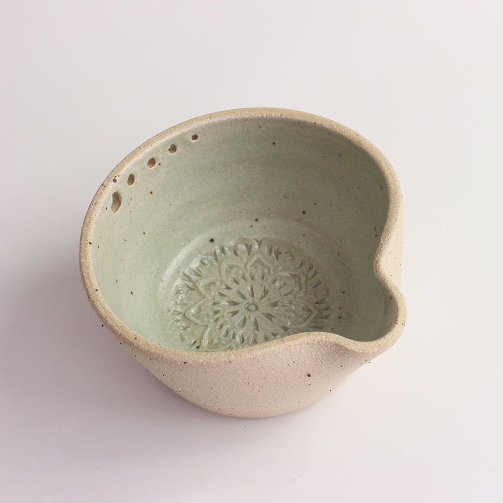 Above view of green herb shredder bowl showing pattern inside