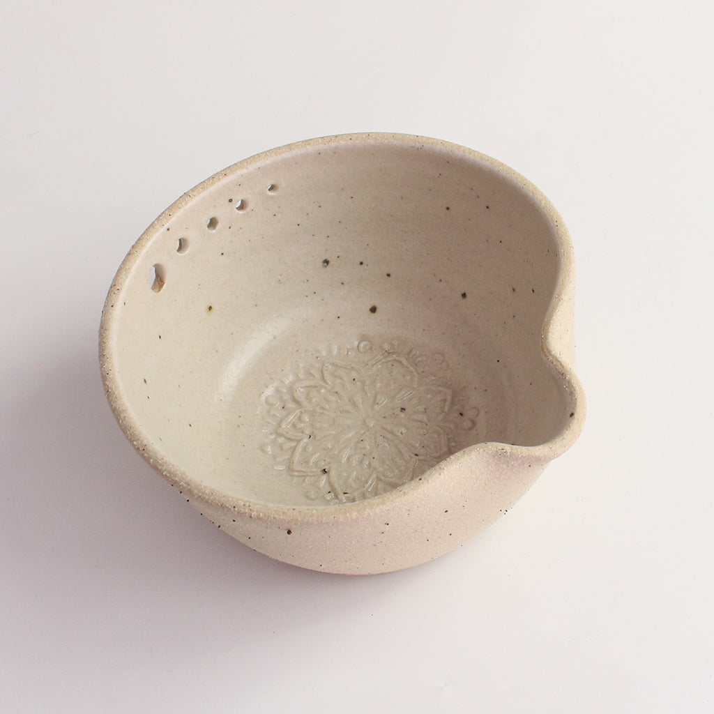 Above view of white herb shredder bowl showing pattern inside