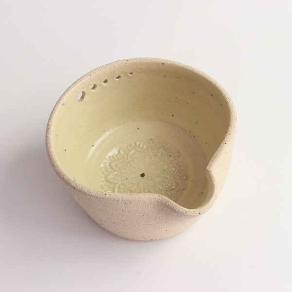 Above view of yellow herb shredder bowl showing pattern inside