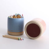 2 match pots, one on its side showing the underside striker pad