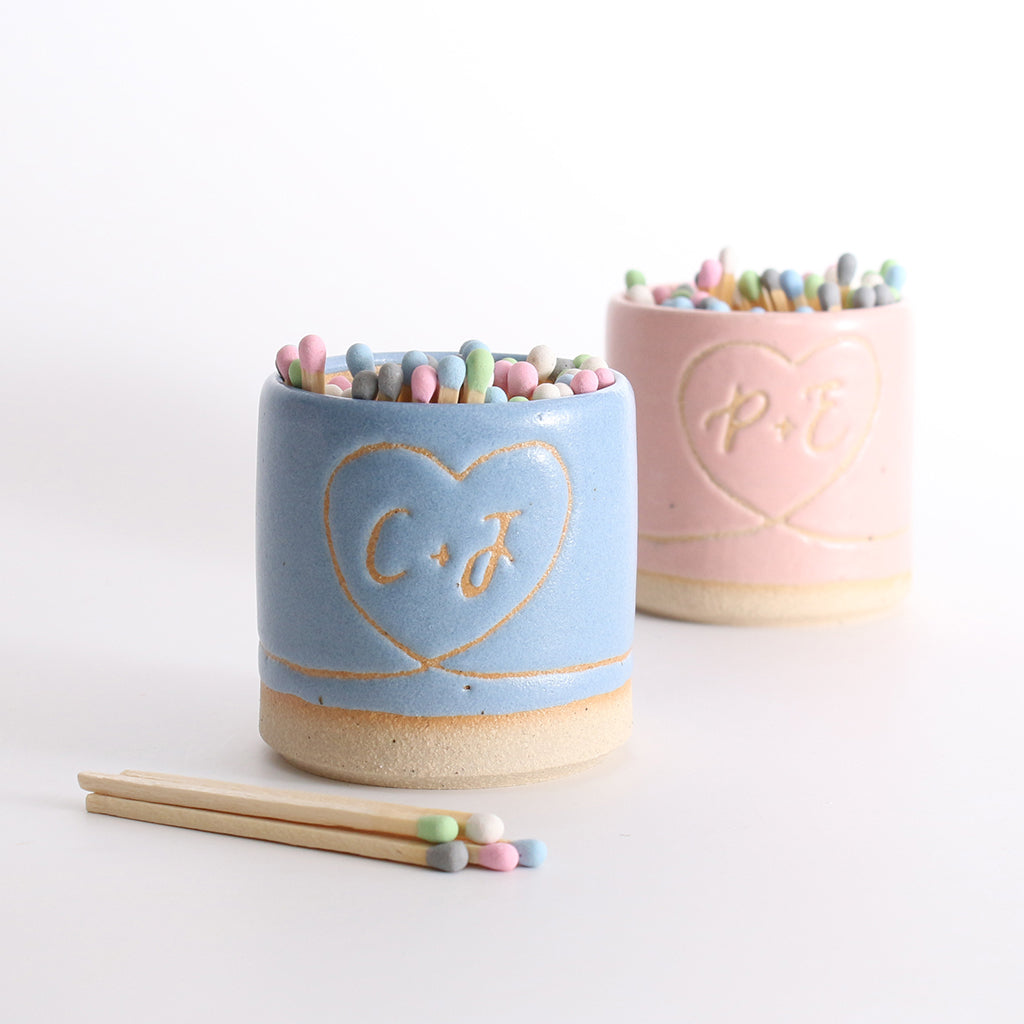 'C+J' blue match pot in front of 'P+E' match pot