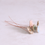 Several handmade ceramic daisy flower stems in different pastel glazes, creating a colourful ceramic bouquet.