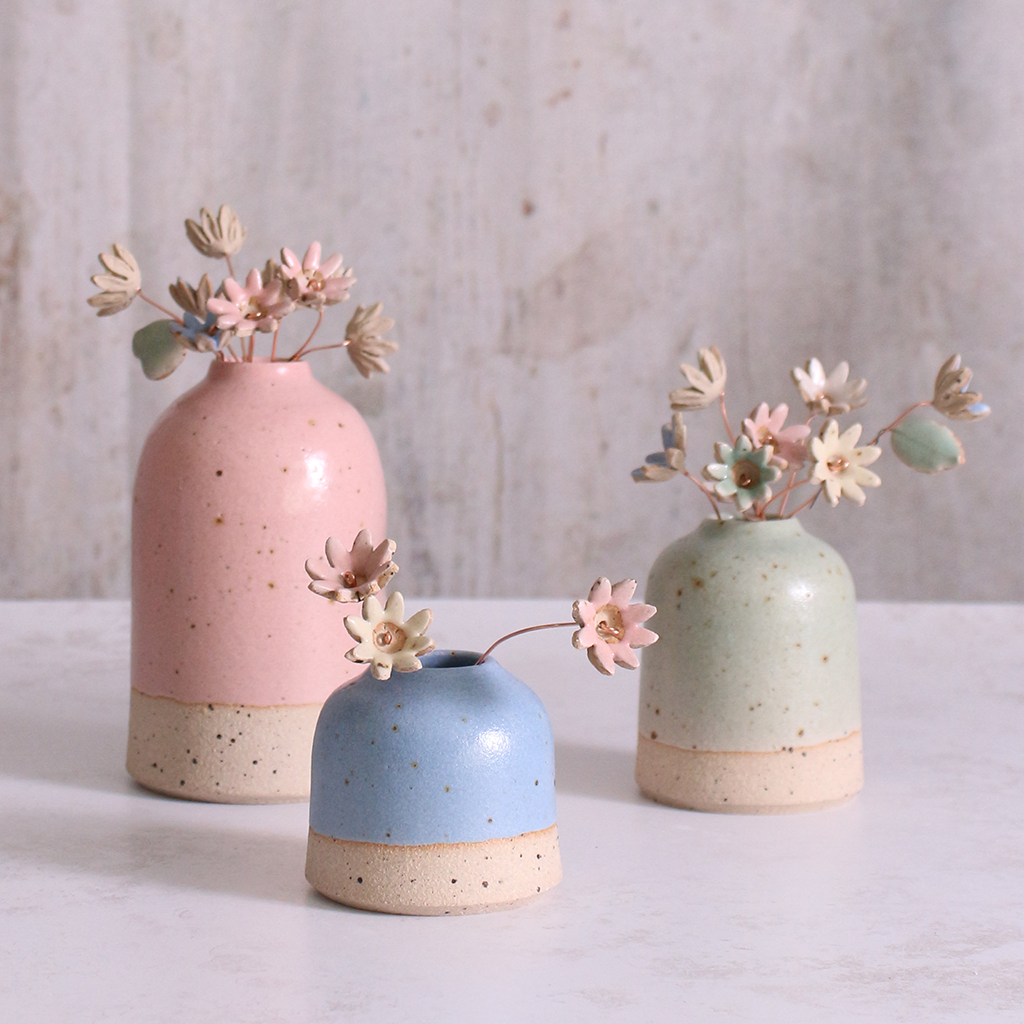 Set of three pastel ceramic daisy flower stems in handcrafted pink, blue, and green vases – unique handmade ceramic home decorations by Habulous
