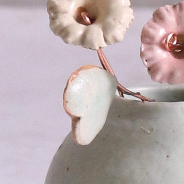 Close-up of pastel ceramic flower stem with heart-shaped ceramic leaf attached, they're on copper wire stems – individually handcrafted floral home accessories from Habulous