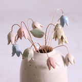 Pastel drop flower stems displayed in a handcrafted speckled vase – artisan home décor by Habulous.