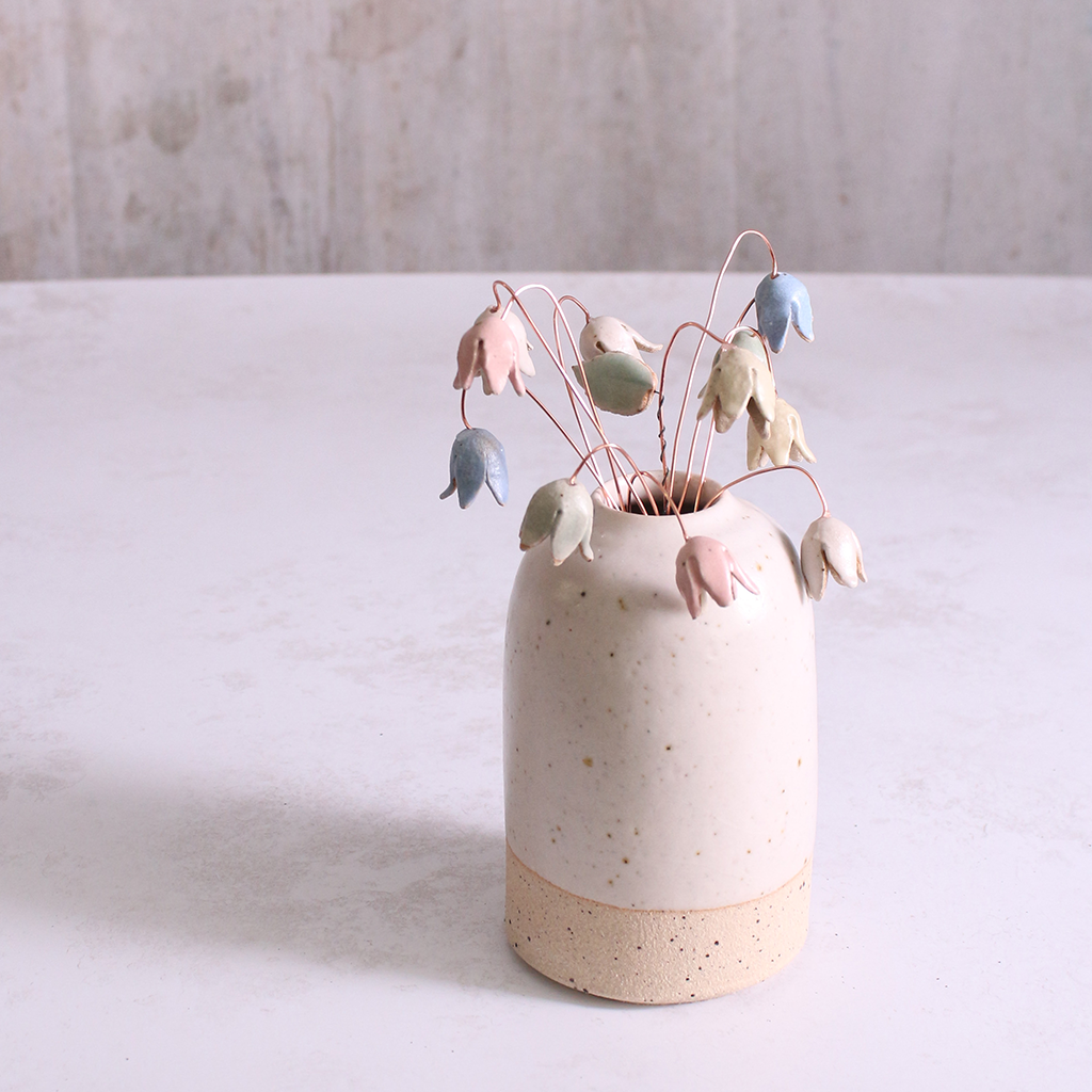 Pastel drop flower stems displayed in a handcrafted off-white speckled vase – artisan home décor by Habulous.